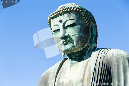 Image of Buddha in Kamakura with sunny blue sky