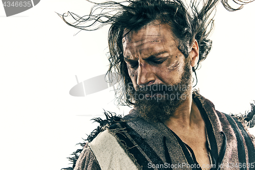 Image of Portrait of a brutal bald-headed viking in a battle posing against a white background.