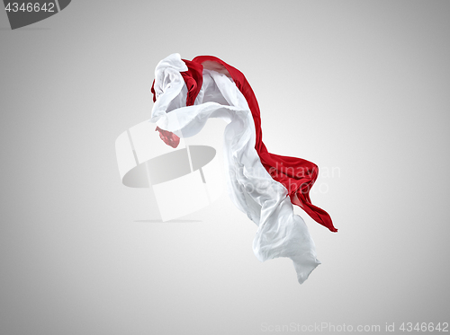 Image of Smooth elegant transparent red and white cloth separated on gray background.