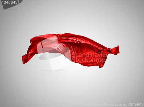 Image of Smooth elegant transparent red cloth separated on gray background.