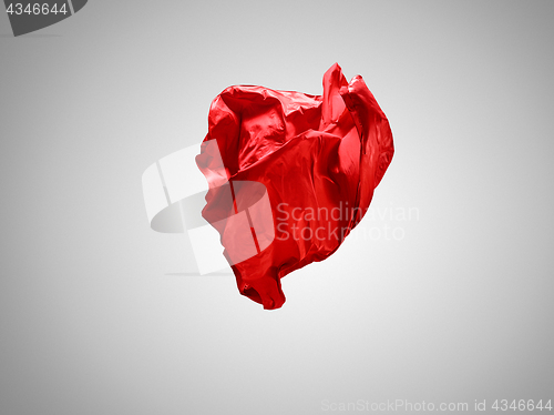 Image of Smooth elegant transparent red cloth separated on gray background.