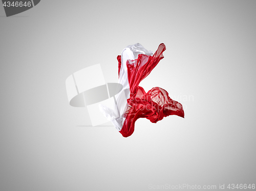 Image of Smooth elegant transparent red and white cloth separated on gray background.
