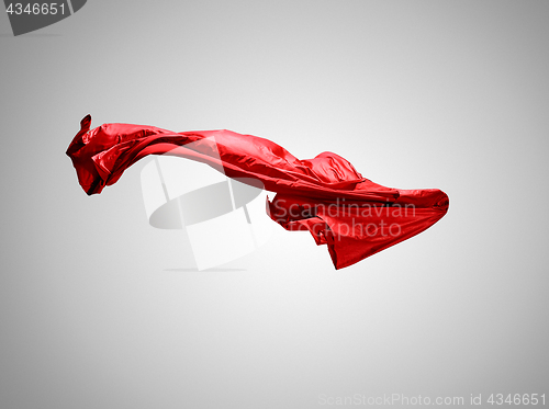 Image of Smooth elegant transparent red cloth separated on gray background.