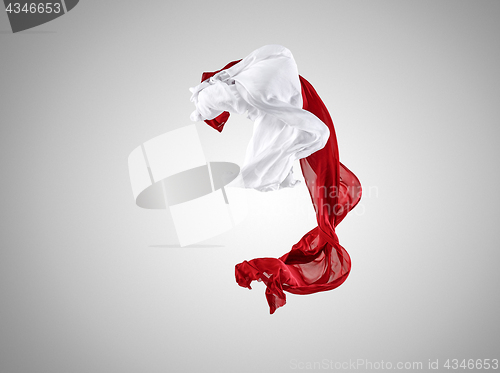 Image of Smooth elegant transparent red and white cloth separated on gray background.