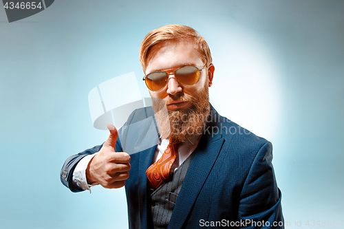 Image of Portrait of a business man isolated on blue background.