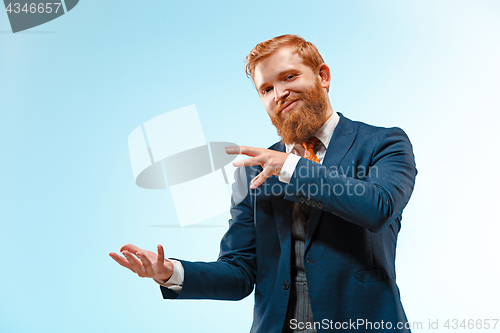 Image of Portrait of a business man isolated on blue background.