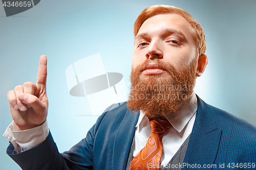 Image of Portrait of a business man isolated on blue background.