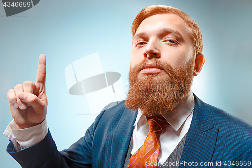 Image of Portrait of a business man isolated on blue background.