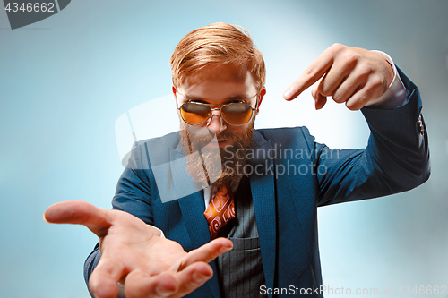 Image of Portrait of a business man isolated on blue background.