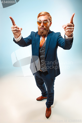 Image of Portrait of a business man isolated on blue background.