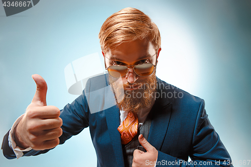 Image of Portrait of a business man isolated on blue background.