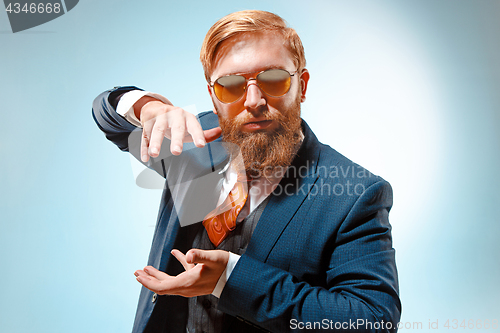 Image of Portrait of a business man isolated on blue background.