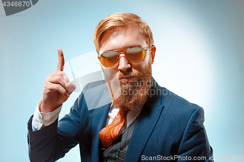 Image of Portrait of a business man isolated on blue background.