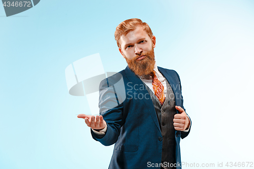 Image of Portrait of a business man isolated on blue background.