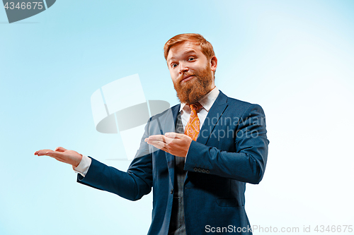 Image of Portrait of a business man isolated on blue background.