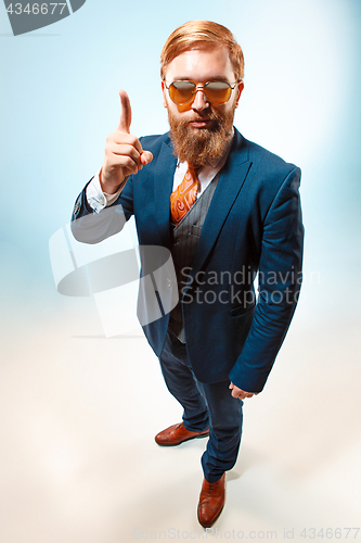 Image of Portrait of a business man isolated on blue background.