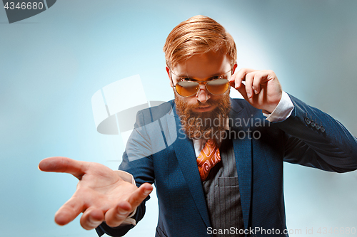 Image of Portrait of a business man isolated on blue background.