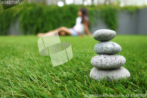 Image of Pebbles stacked up on grass