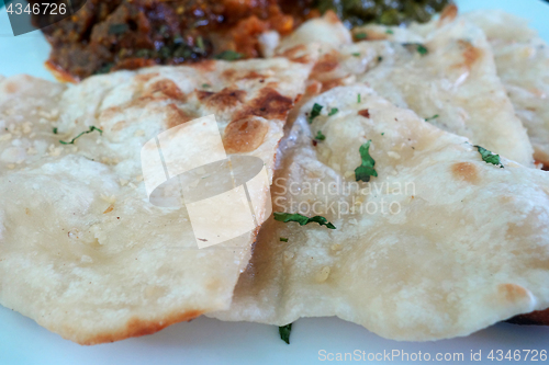 Image of Garlic and coriander naan on a plate