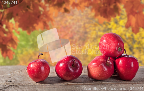 Image of Red apples on a wooden table