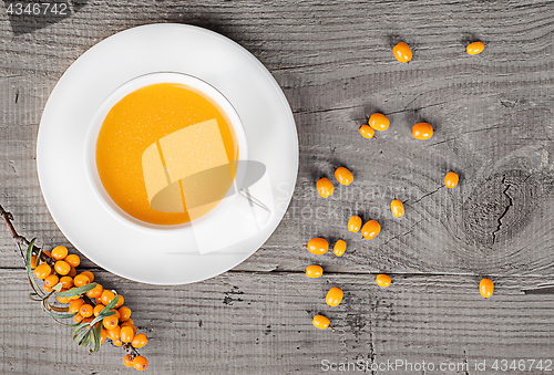 Image of Sea buckthorn juice on a wooden table