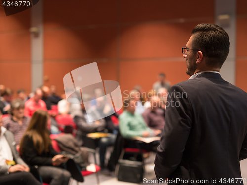 Image of Public speaker giving talk at Business Event.