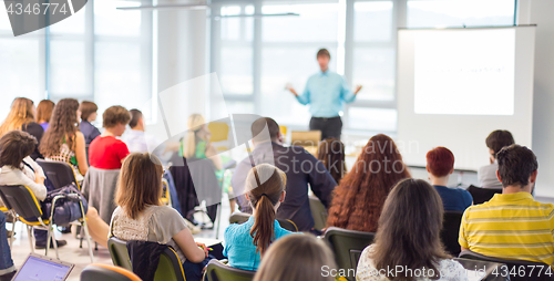 Image of Speaker giving presentation on business conference.