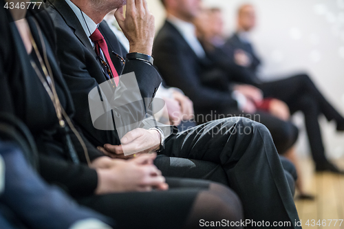 Image of Row of business people sitting at seminar.