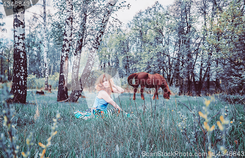 Image of Blonde Woman Resting In The Grass