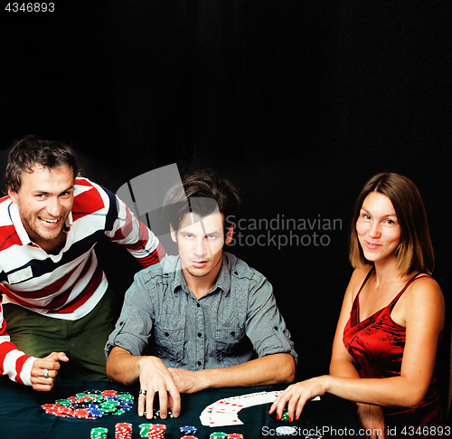 Image of young people playing poker on black background