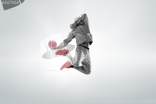 Image of Full length portrait of a basketball player with ball