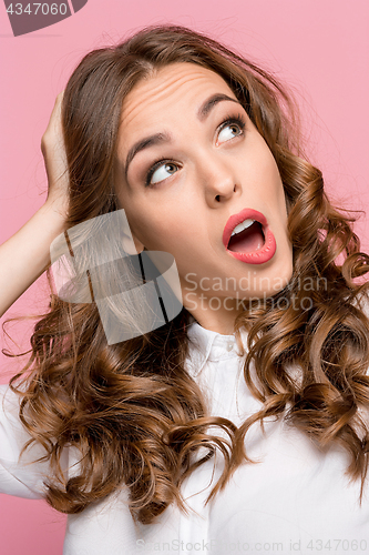 Image of Surprised happy beautiful woman looking sideways in excitement.