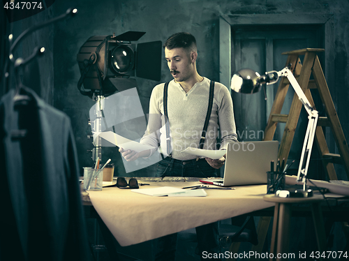 Image of Architect working on drawing table in office