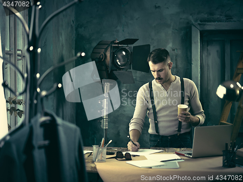 Image of Architect working on drawing table in office