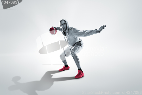 Image of Full length portrait of a basketball player with ball