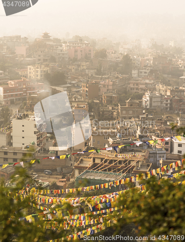 Image of Kathmandu city view and prayer flags after sunrise