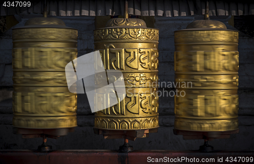 Image of Buddhist shiny prayer wheels in motion