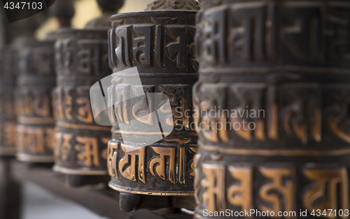 Image of Buddhism obsolete prayer wheels in row 