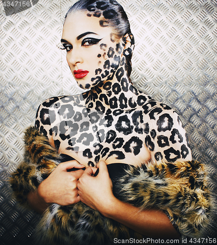 Image of young sexy woman with leopard make up all over body, cat bodyart closeup, depression