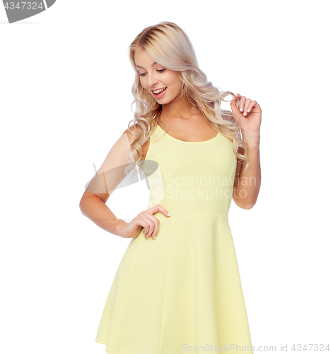 Image of happy smiling beautiful young woman in dress