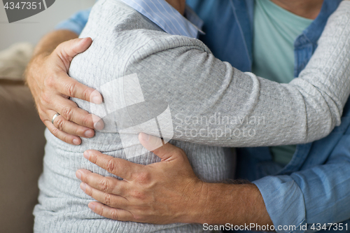 Image of close up of married senior couple hugging