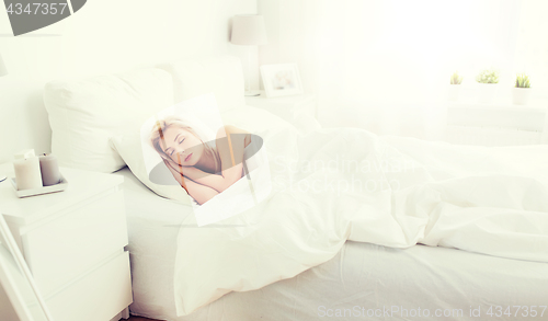 Image of young woman sleeping in bed at home bedroom