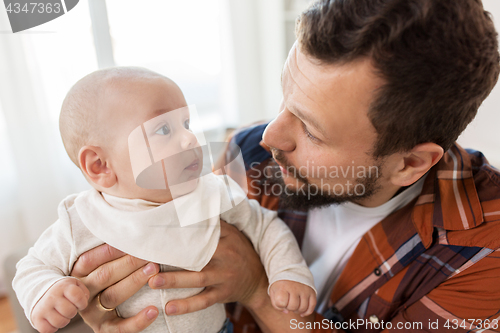 Image of close up of father with little baby boy at home
