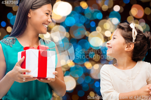 Image of happy mother and daughter girl with gift box