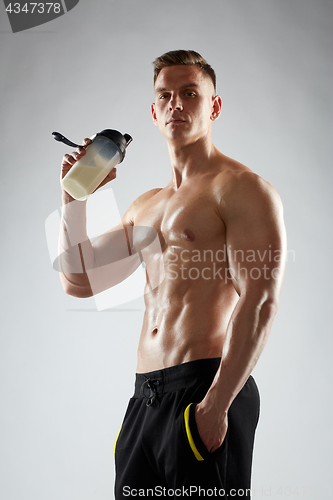 Image of young man or bodybuilder with protein shake bottle