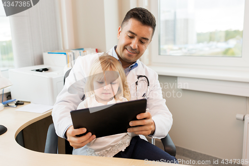 Image of doctor and little girl with tablet pc at clinic