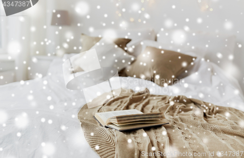 Image of book on bed in bedroom at christmas home