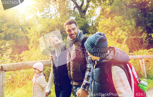 Image of happy family with backpacks hiking