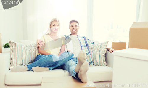 Image of happy couple with big cardboard boxes at new home