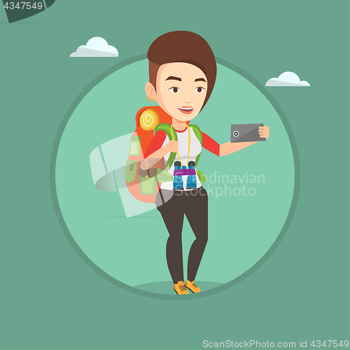 Image of Woman with backpack making selfie.